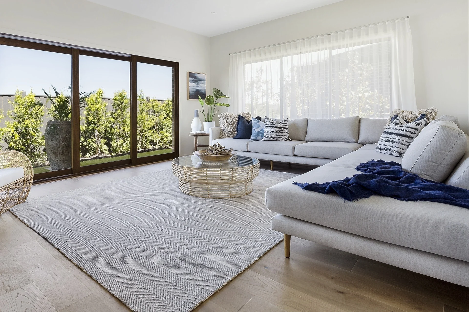 modern coastal living room with light grey sofa and navy throws